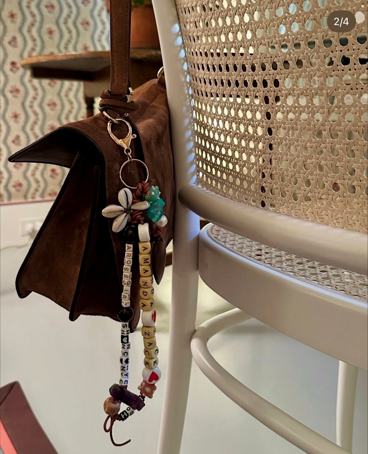 Brown bag with keychain charm hanging on a chair