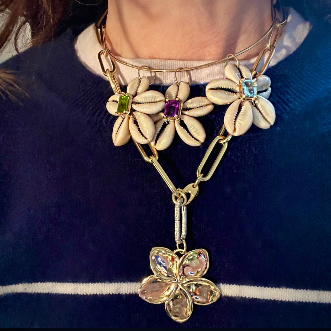 Necklace with floral design and gemstones on a blue background