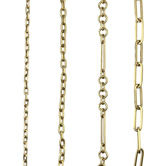 Four gold chain necklaces of different styles on a white background