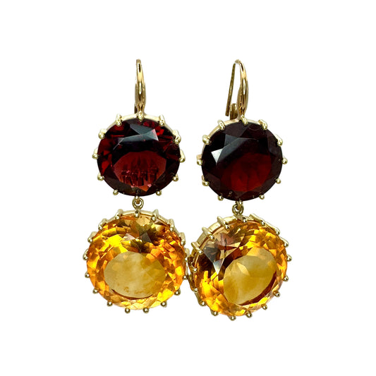 Pair of earrings with red and yellow gemstones on a white background.