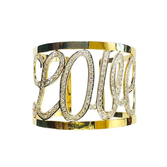 Gold bracelet with 'LOVE' letters on a light gray background