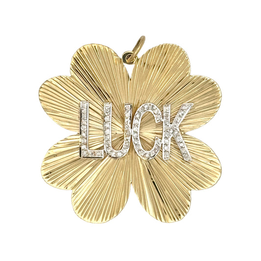 Gold pendant with 'LUCK' text on a white background