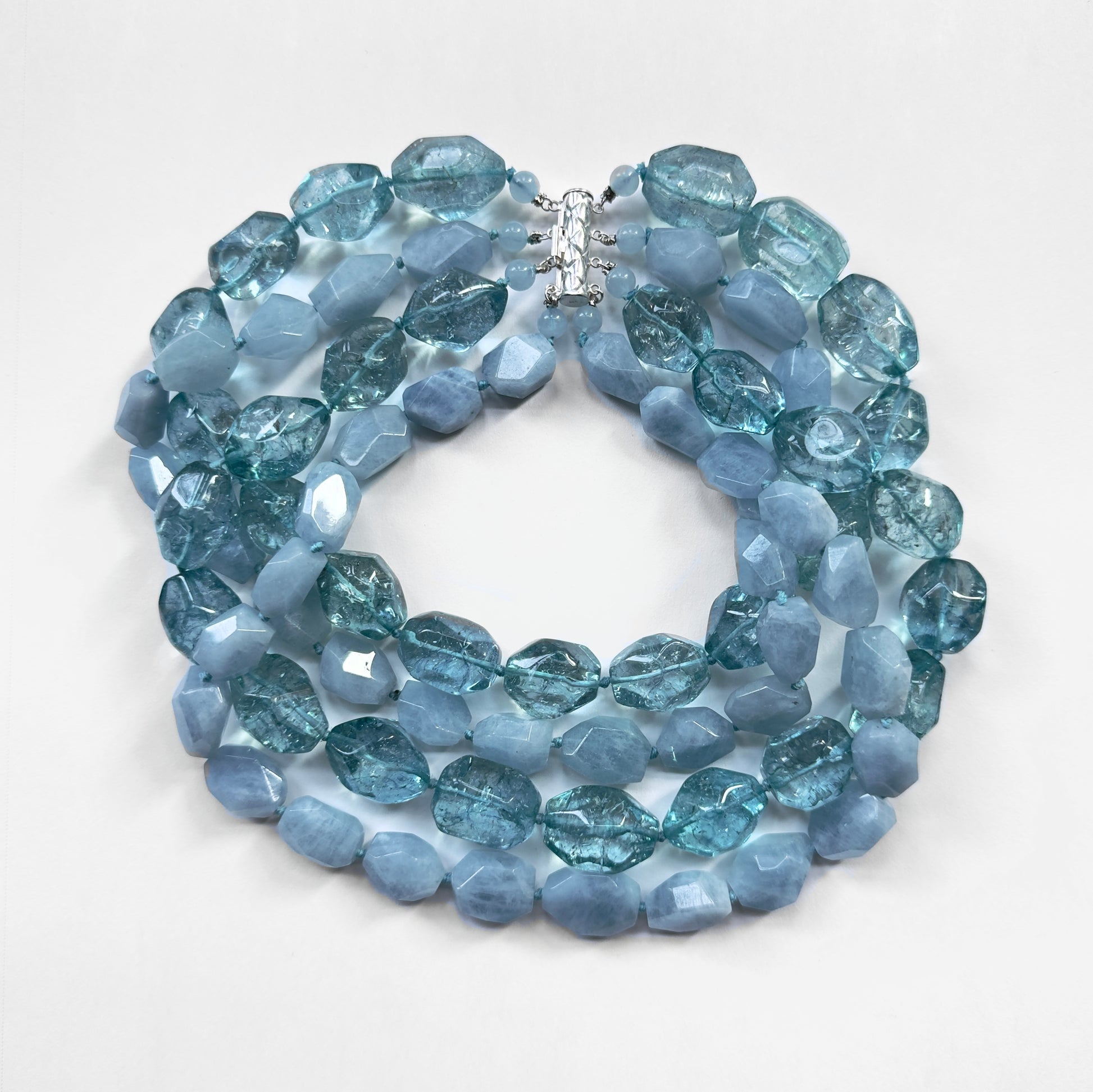 Blue beaded necklace on a white background