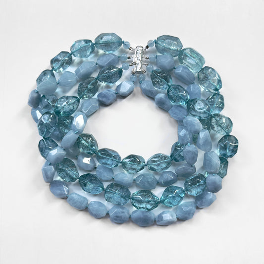 Blue beaded necklace on a white background