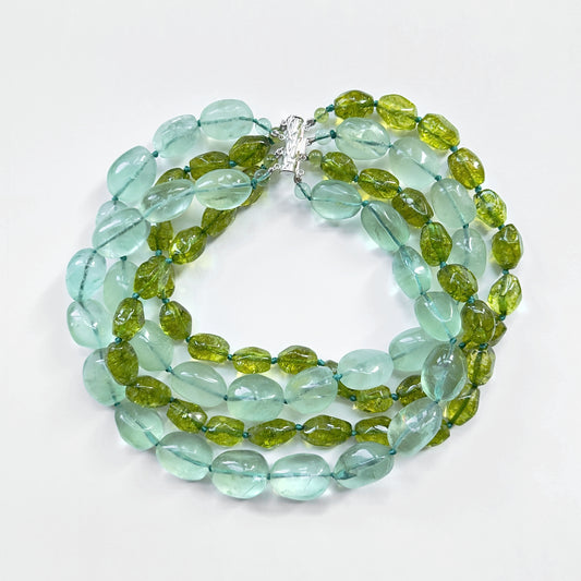 Green beaded necklace on a white background