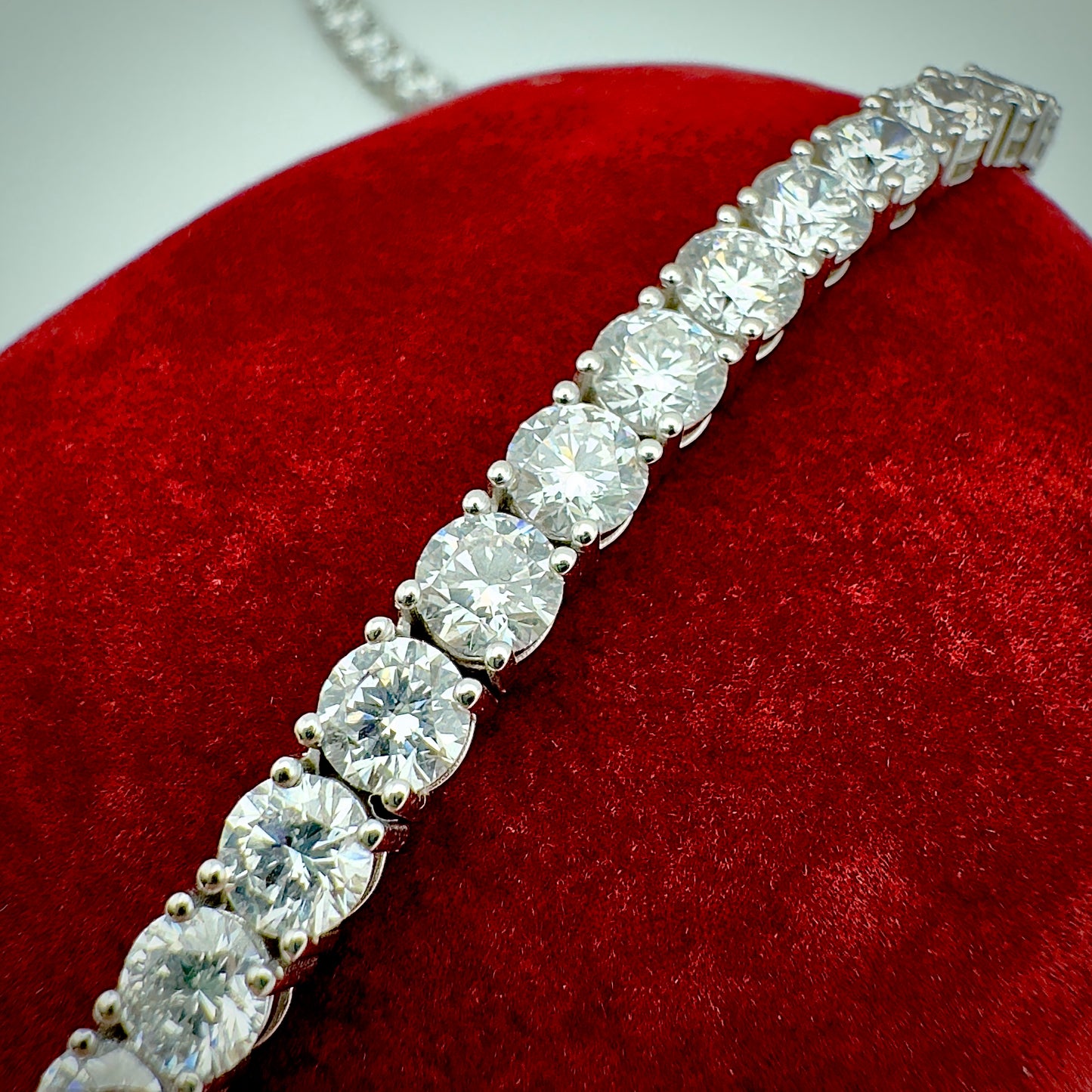 Close-up of diamond necklace on a red velvet surface