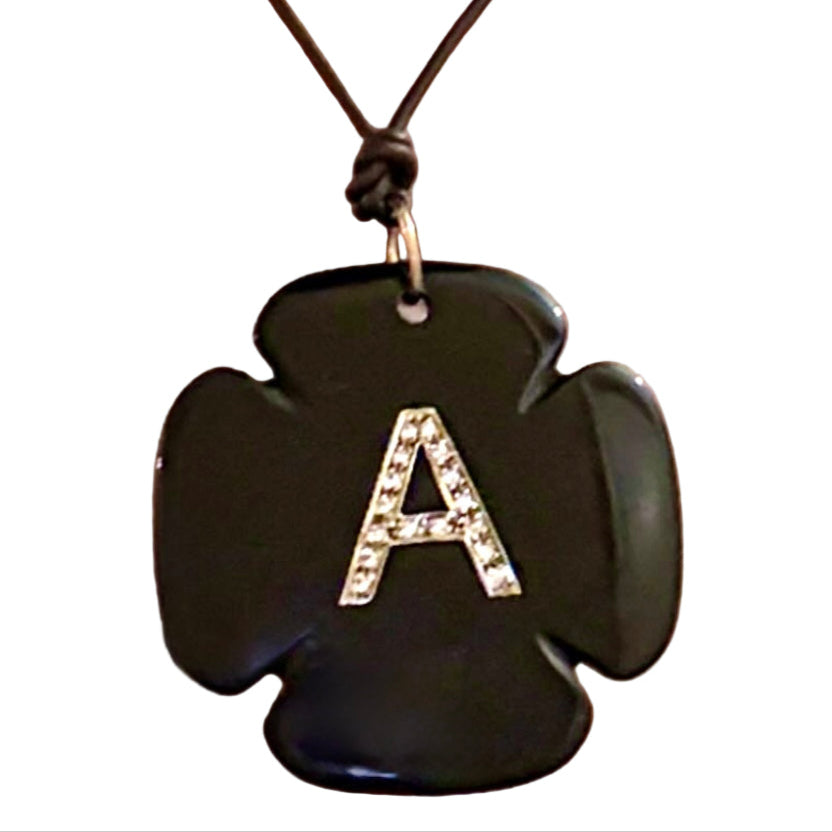 Necklace with a black cross-shaped pendant and letter 'A' on a white background