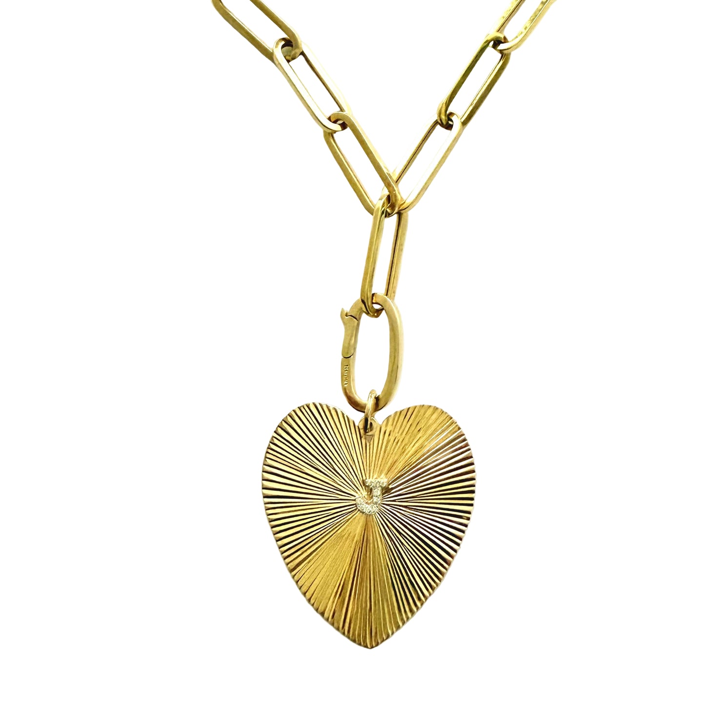 Gold heart-shaped pendant on a gold chain on a white background