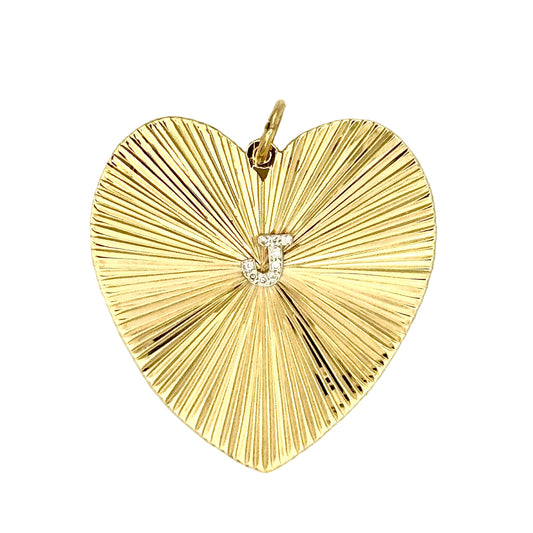 Gold heart-shaped pendant, etched radiating surface, with 'J' in diamonds in the center.