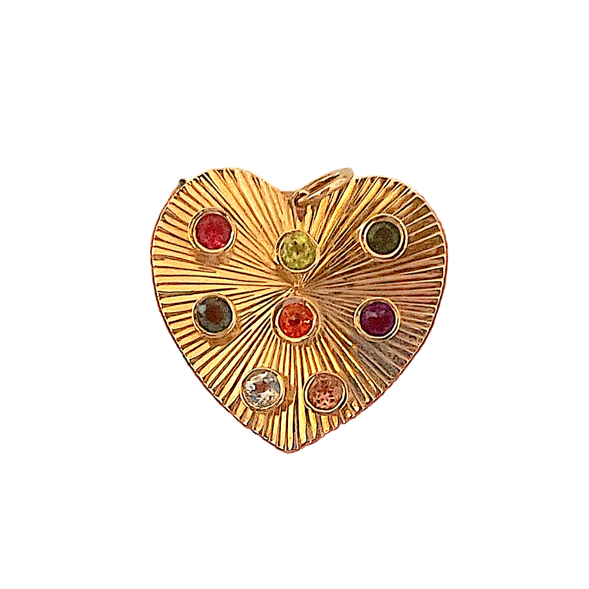 Gold heart-shaped earring with embedded gemstones held between fingers against a patterned background