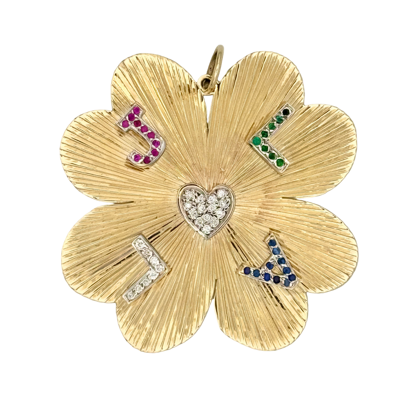 Gold clover-shaped pendant with embedded gemstones on a white background