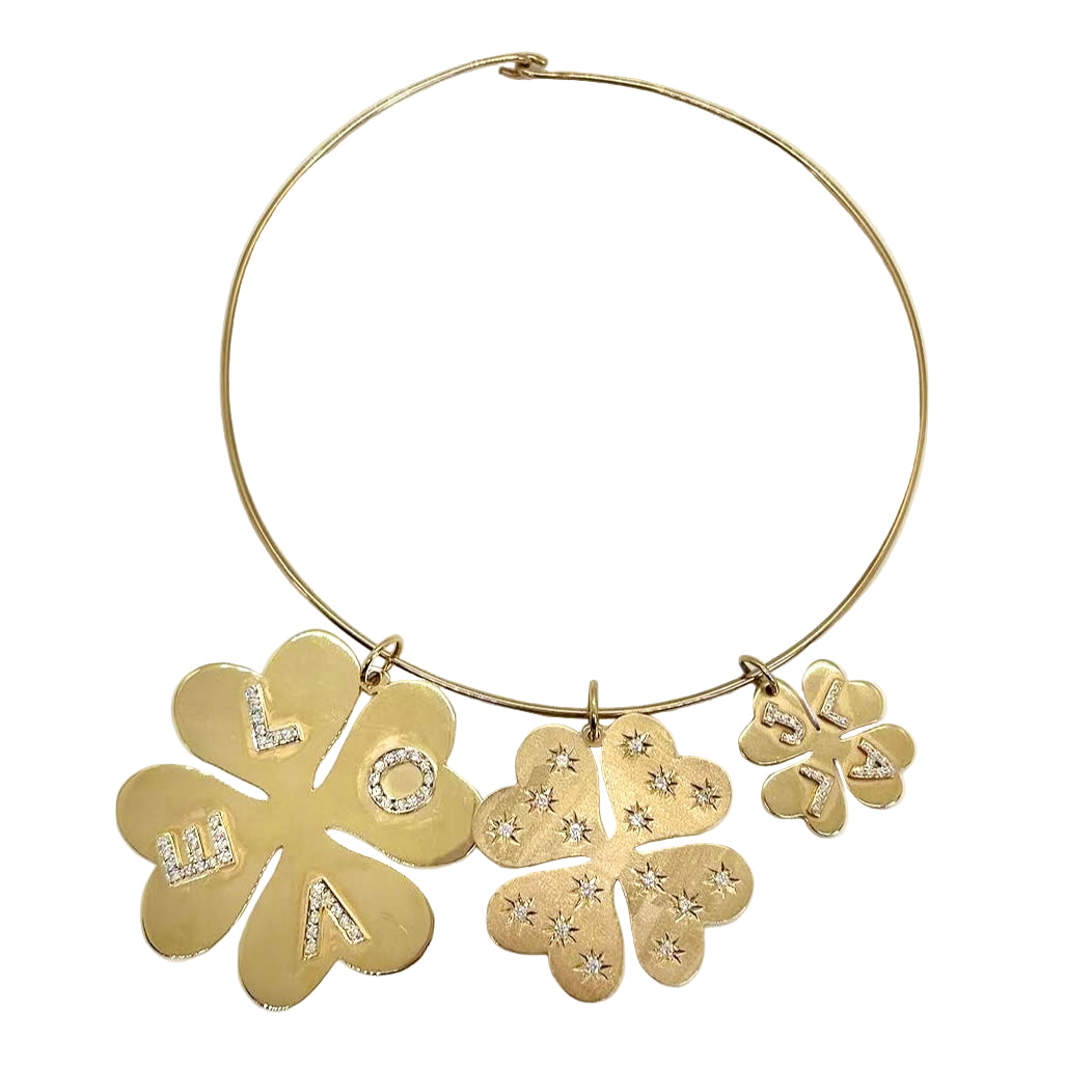 Gold necklace with clover pendants on a white background