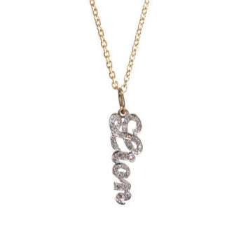 A 14K yellow gold charm with pave diamonds in the shape of a customizable name, displayed on a gold chain.