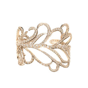 A 14k white gold cuff bracelet with pave diamonds, featuring a detailed feather pattern.