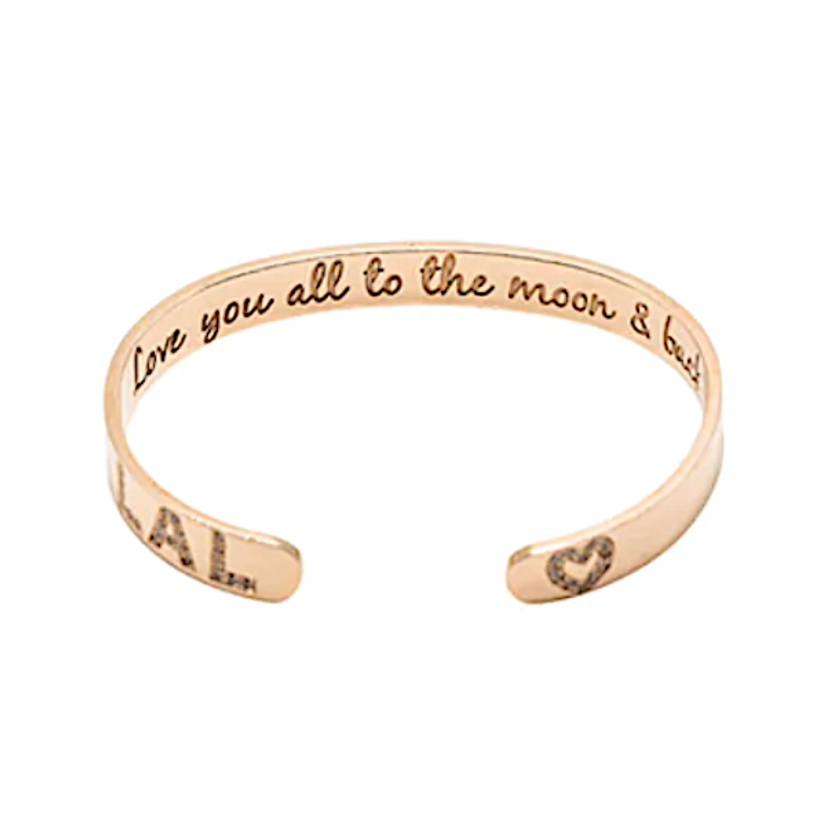 A rose gold cuff bracelet with engraved text and pave diamonds.