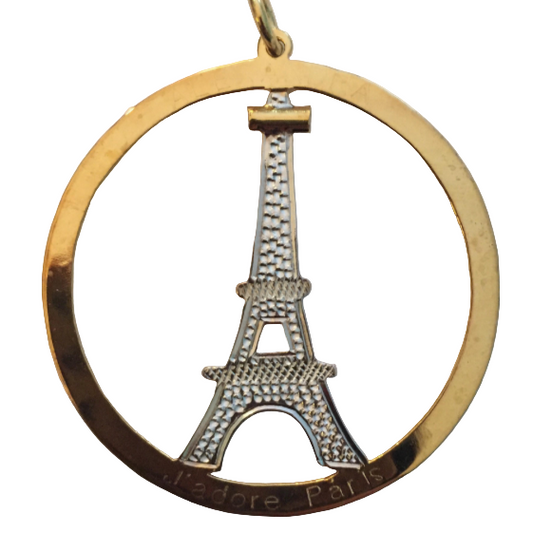 A gold-colored pendant featuring a diamond-encrusted Eiffel Tower design with the word 'Love' and 'Paris' on a chain.