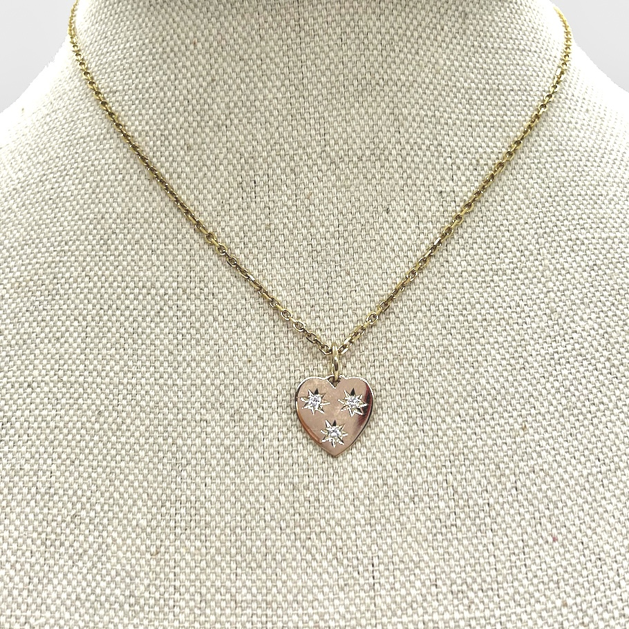 Small heart shaped pendant necklace with diamonds on bust.