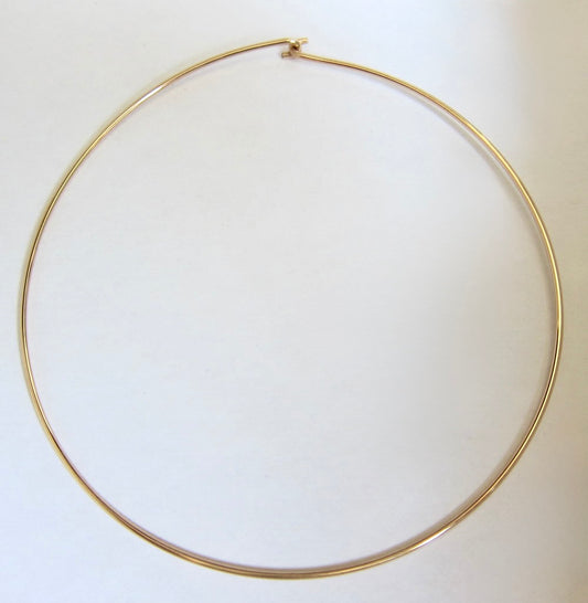 Gold hoop wire choker necklace on a white background