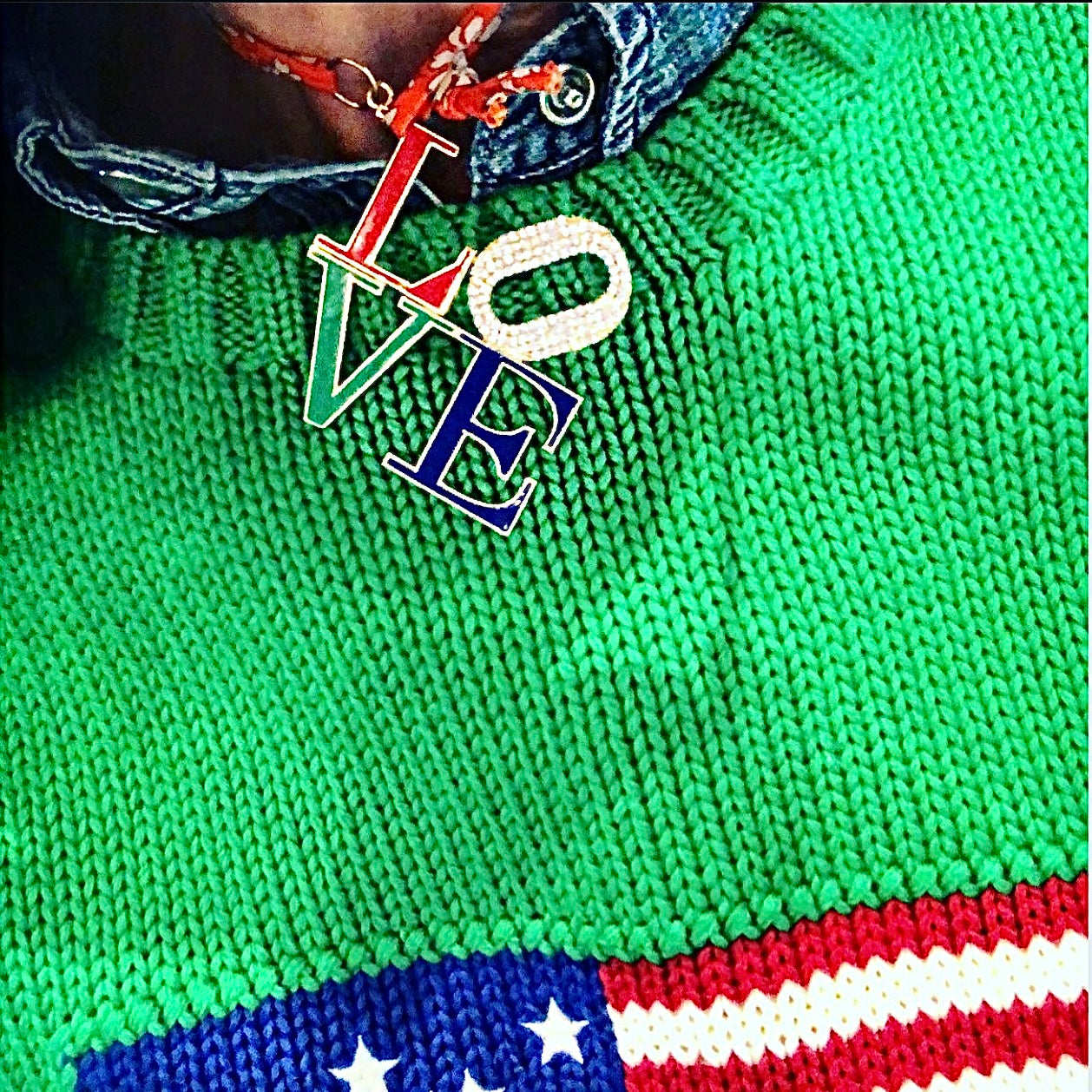 Green knitted sweater with 'LOVE' pendant and American flag design