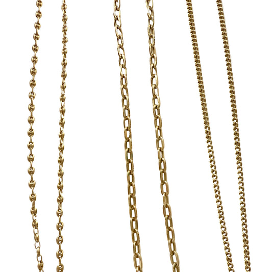 Four gold chains of different designs on a white background