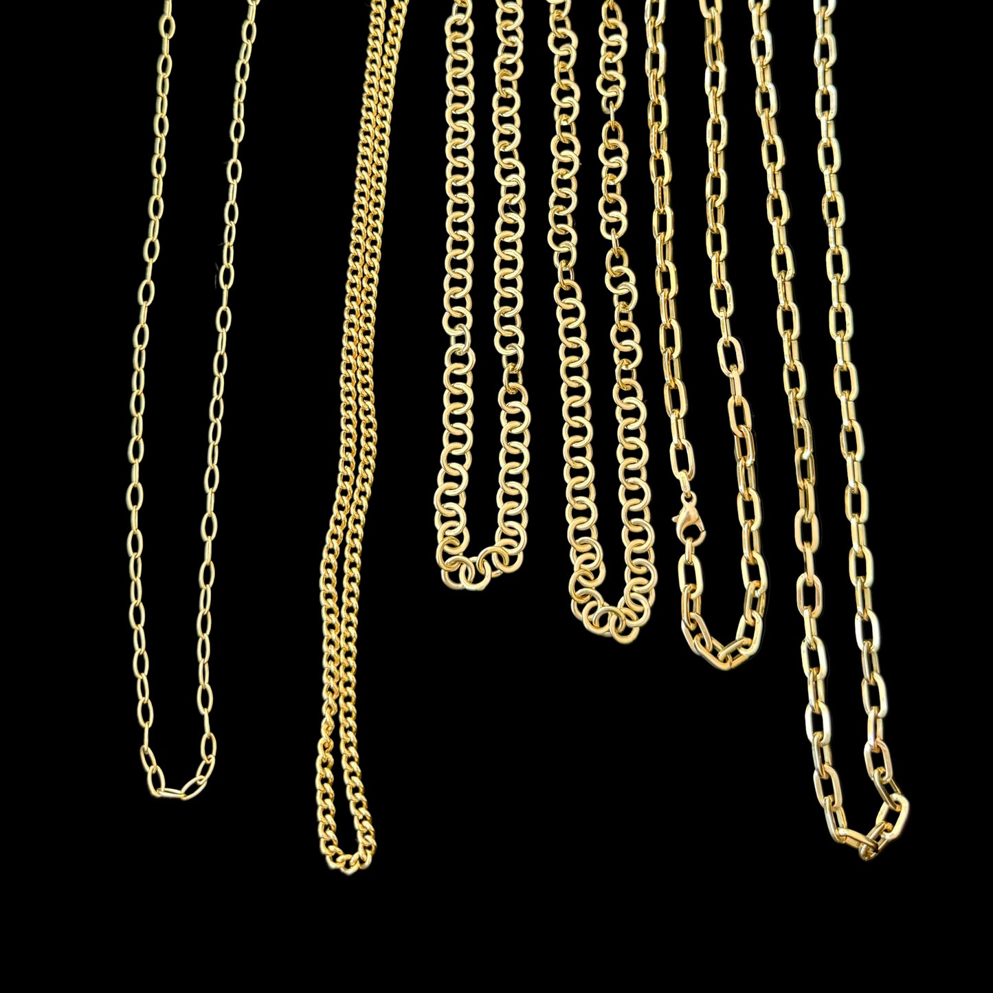 Gold chains displayed on a black background