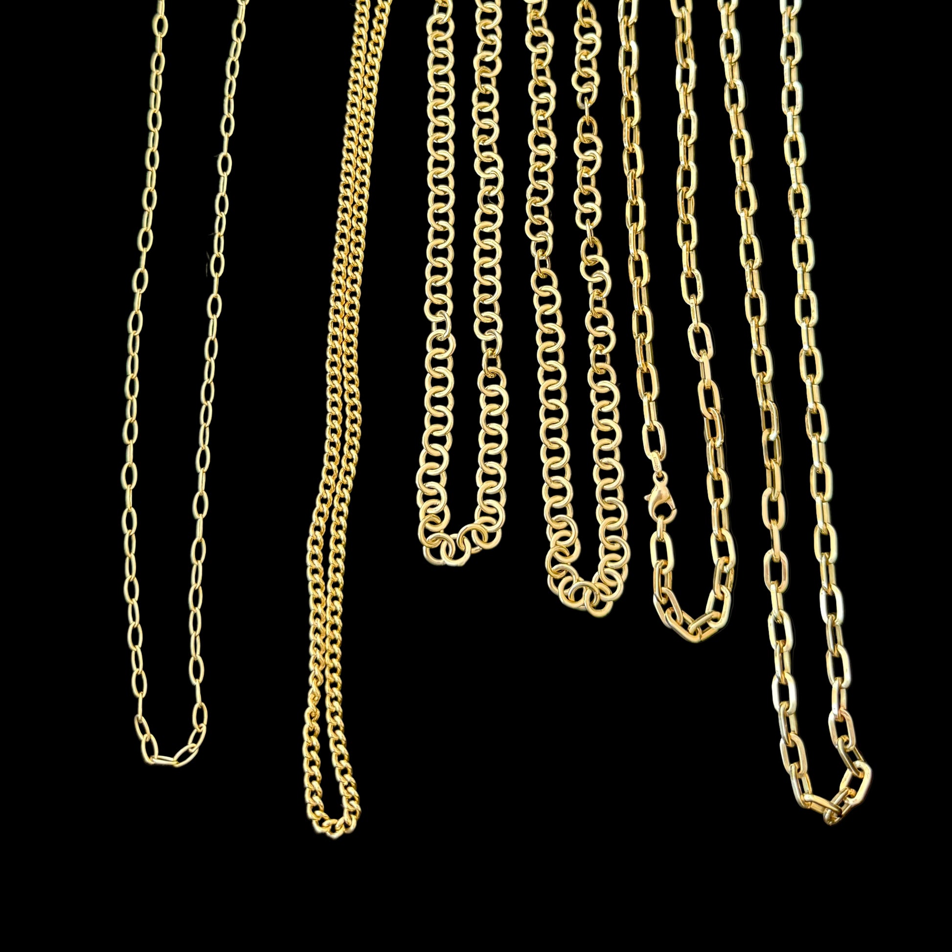Gold chains displayed on a black background