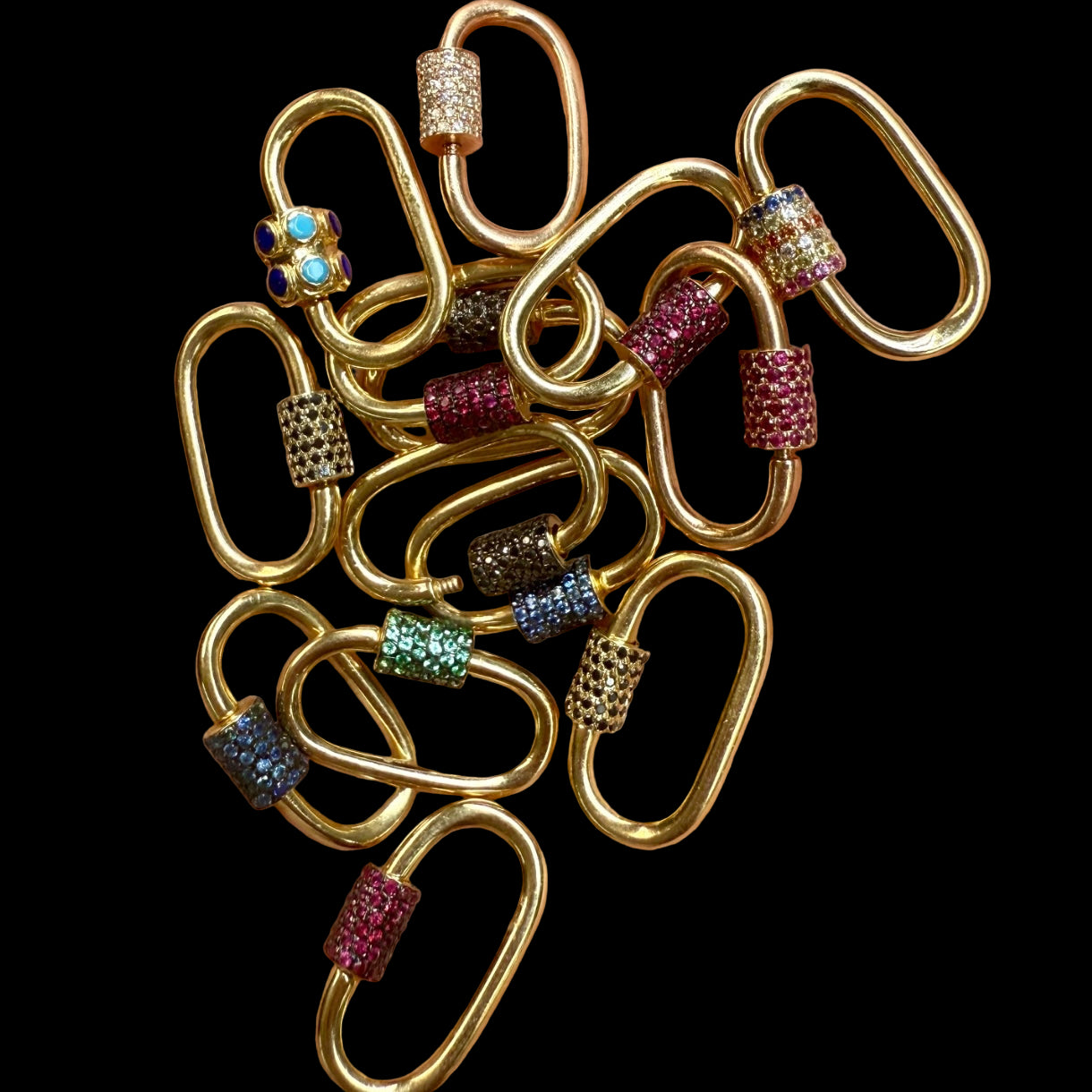 Gold chain links with colorful gemstones on a hand