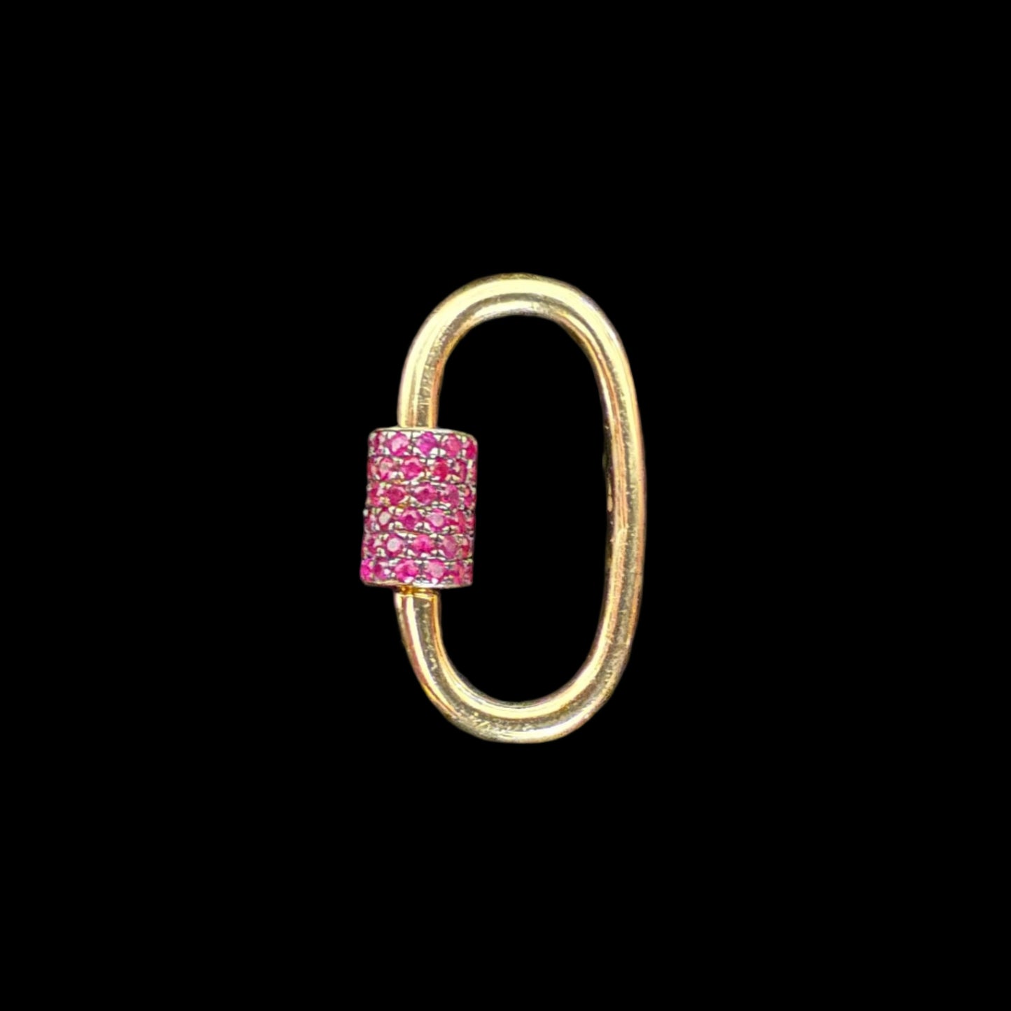 Gold loop clip with a pink gemstone on a black background