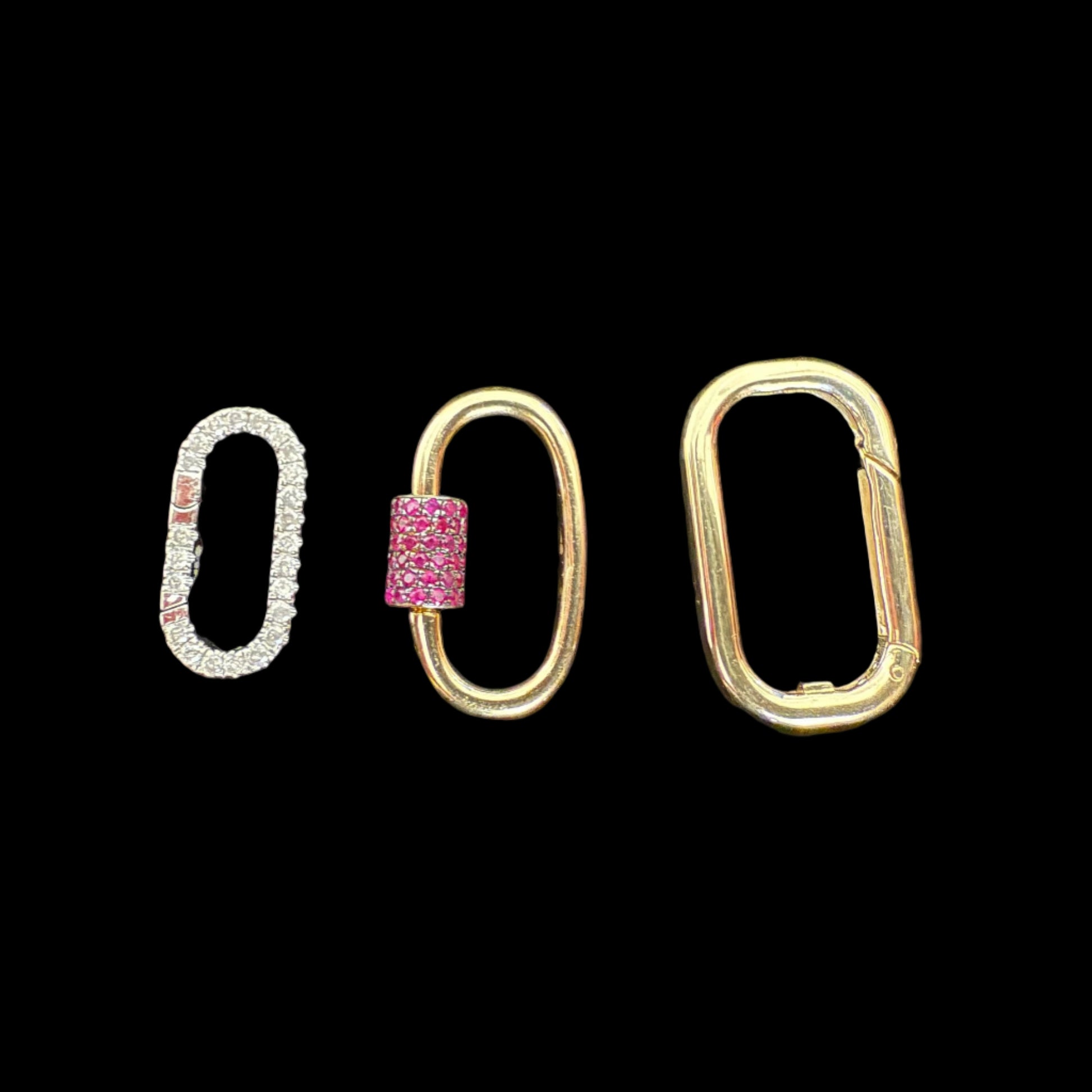 Three gold loop clips with different designs on a black background