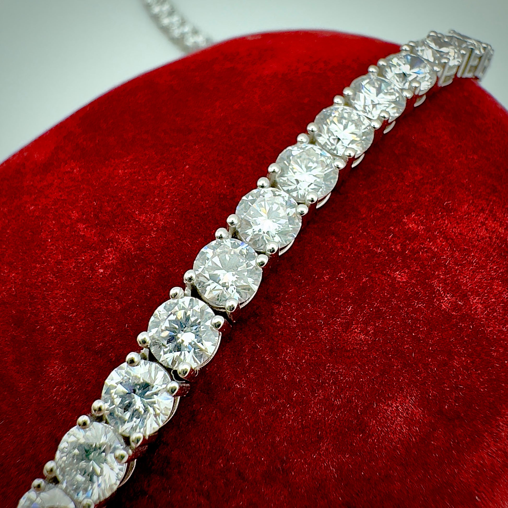 Close-up of diamond necklace on a red velvet surface