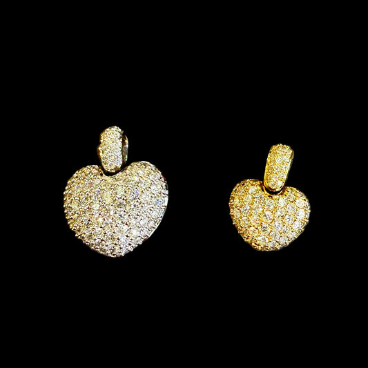 Heart-shaped diamond charms on a black background