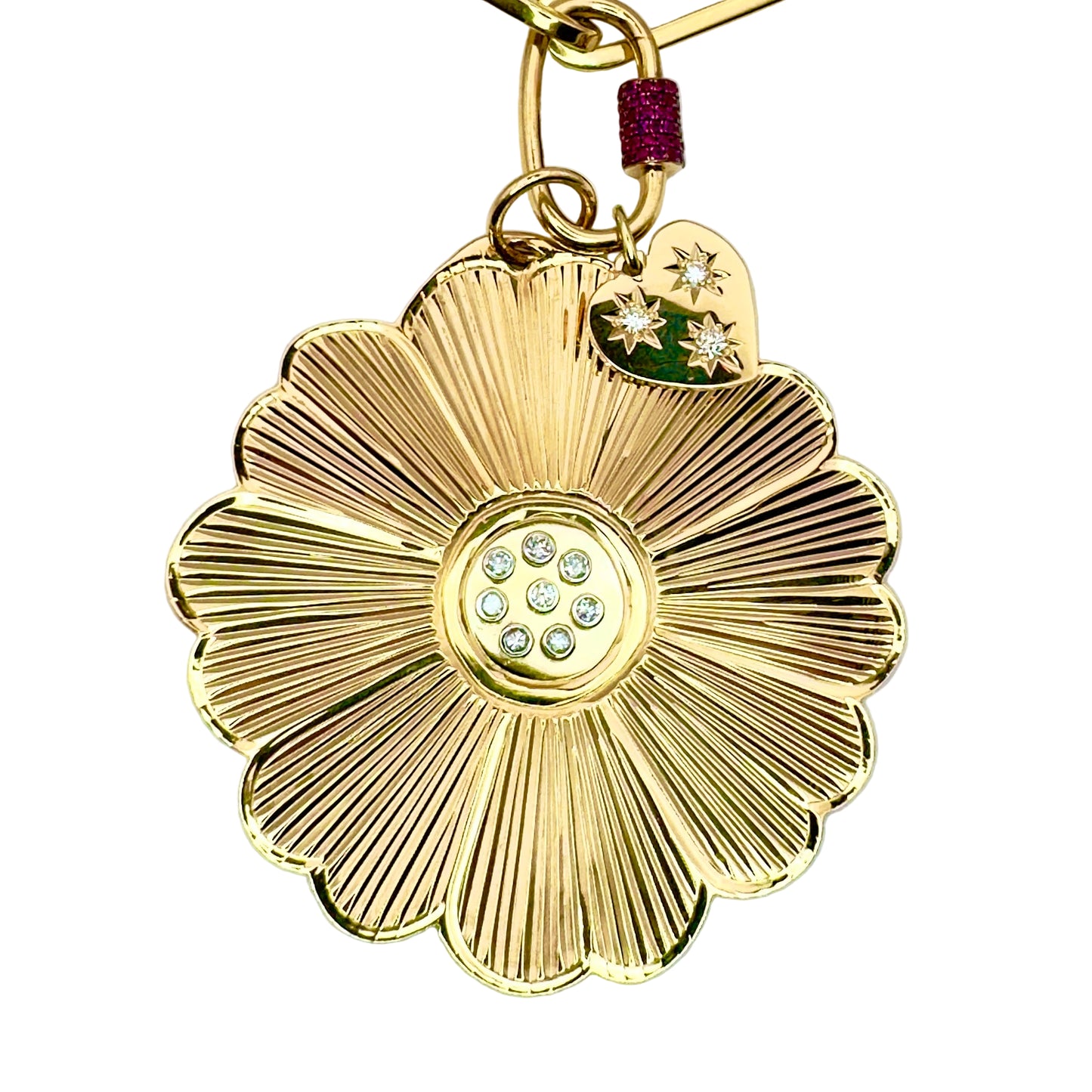 Gold flower-shaped keychain with gemstone center on a white background