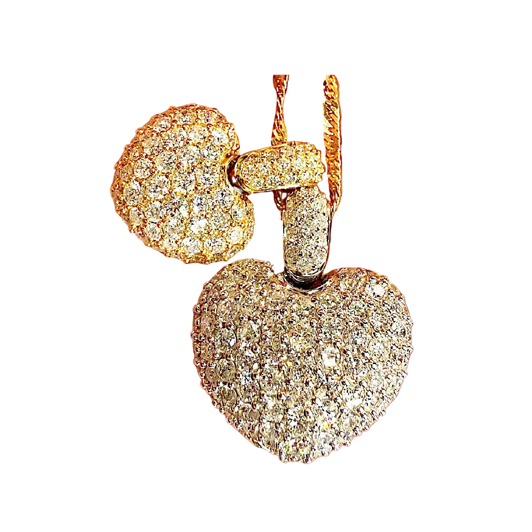 Gold heart-shaped earrings with diamonds on a white background