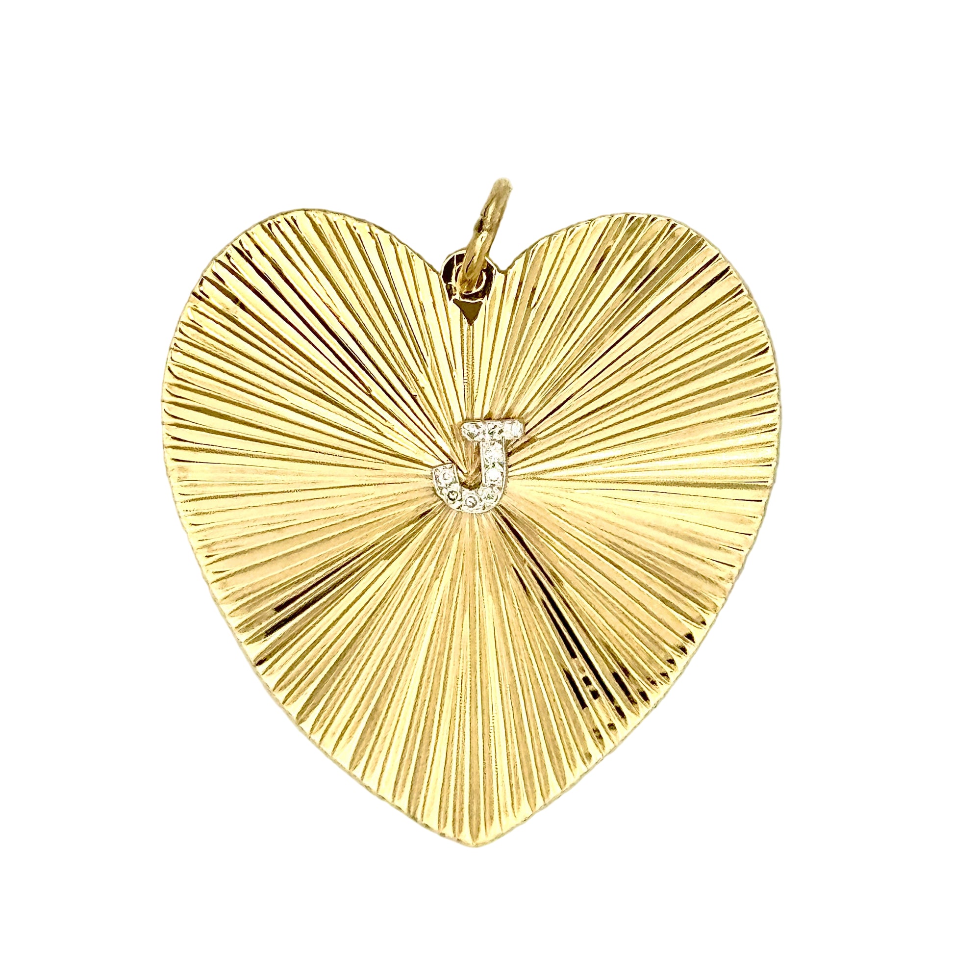 Gold heart-shaped pendant, etched radiating surface, with 'J' in diamonds in the center. 