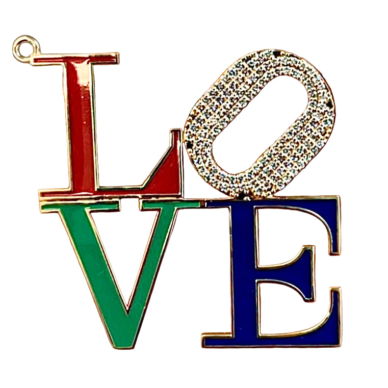 Colorful 'LOVE' letter charm held in a hand