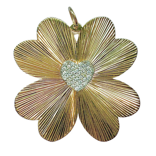 Gold flower-shaped pendant with a heart centerpiece on a white background