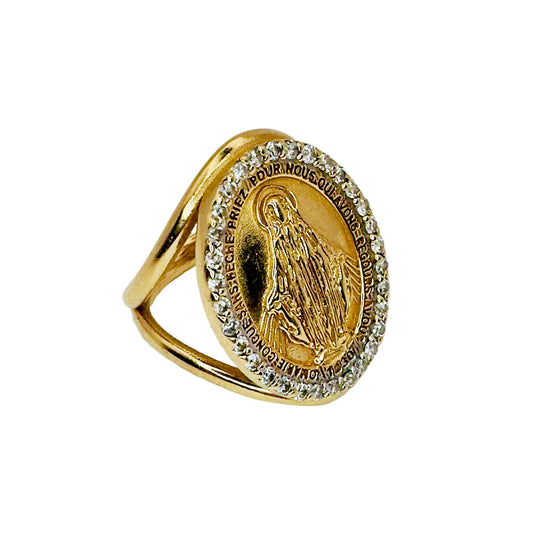 Gold ring with religious emblem and diamond accents on a white background