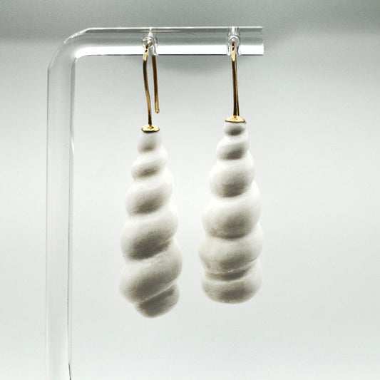 Pair of white earrings hanging with white background