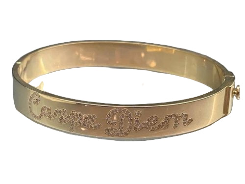 A 14kt gold engraved bracelet with pave diamonds, featuring a script or block lettering on the inside.