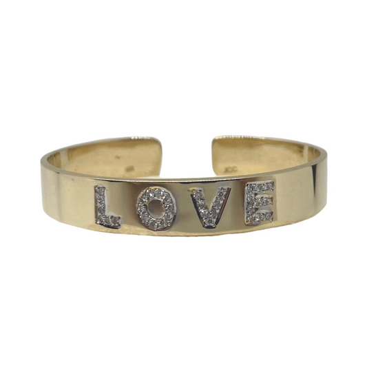 A 14K rose gold cuff bracelet with pave diamond letters spelling 'LOVE'.