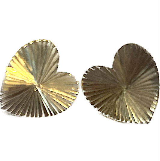 A pair of gold-colored heart-shaped post earrings with a textured surface.