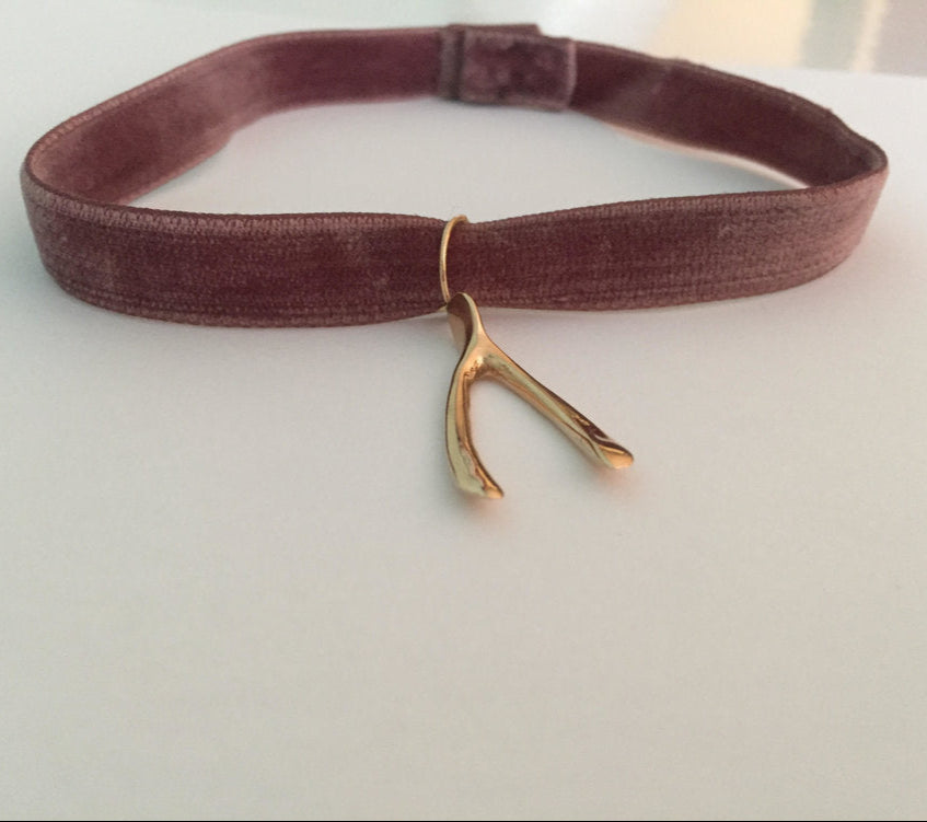 Gold wishbone charm on velvet choker